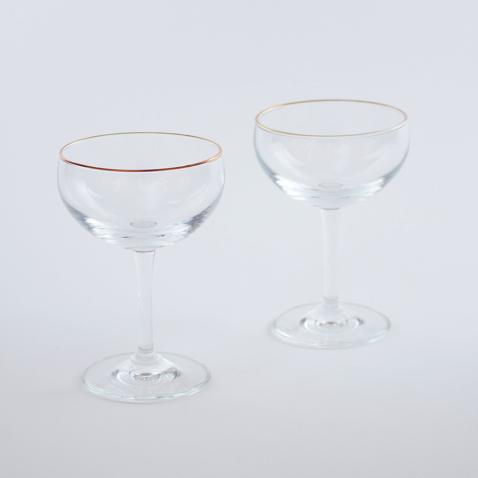 https://store.vinepair.com/cdn/shop/products/Bronze-rimmed-cocktail-glass-angle_1600x.jpg?v=1497987473